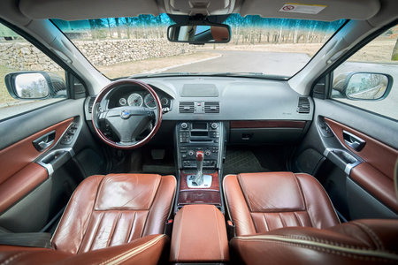 Berlin - October 2021:: Volvo XC90 2.5 1st generation Twilight Bronze 2002-20014 restyling 4WD 4wheel 4x4 SUV brown leather car interior, dashboard and wooden steering wheel with heating function.のeditorial素材
