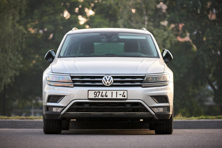 Minsk, Belarus - May, 28 2023: Volkswagen Tiguan II compact 4motion crossover car SUV manufactured by Volkswagen 2016 to present, frontside view parked in street over green foliage background.のeditorial素材