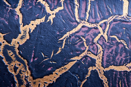 Closeup shot of cracked with caverns glazed deep blue, purple and golden handmade ceramics texture background focus stacking image.の写真素材