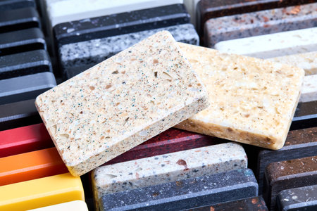 Porcelain stoneware artificial stone square samples as kitchen countertop examples of future kitchen fasade exterior. Samples slabs of natural granite marble quartz for stone countertops close up.の写真素材