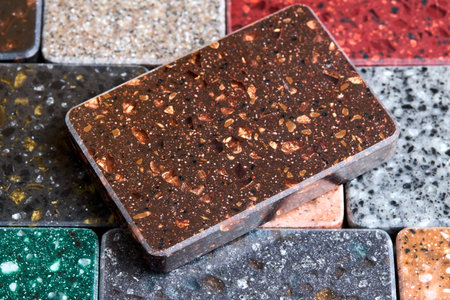 Porcelain stoneware artificial stone square samples as kitchen countertop examples of future kitchen fasade exterior. Samples slabs of natural granite marble quartz for stone countertops close up.の写真素材
