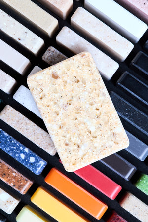 Porcelain stoneware artificial stone square samples as kitchen countertop examples of future kitchen fasade exterior. Samples slabs of natural granite marble quartz for stone countertops close up.の写真素材