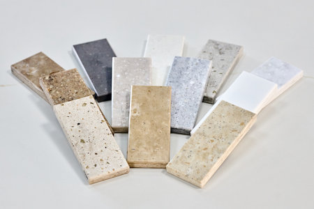 Porcelain stoneware artificial stone square samples as kitchen countertop examples of future kitchen fasade exterior. Samples slabs of natural granite marble quartz for stone countertops close up.の写真素材
