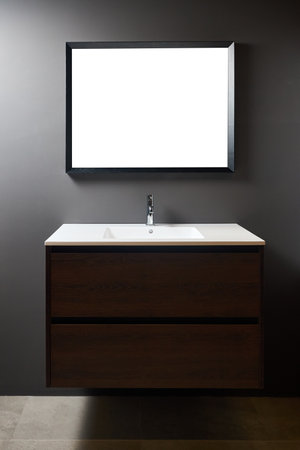 Stand with sink and supplies near dark tiled wall in bathroom with dim lights semi darkness twilight and mirror with frame mockup copyspace Contemporary bathroom detail of rustic loft interior conceptの写真素材