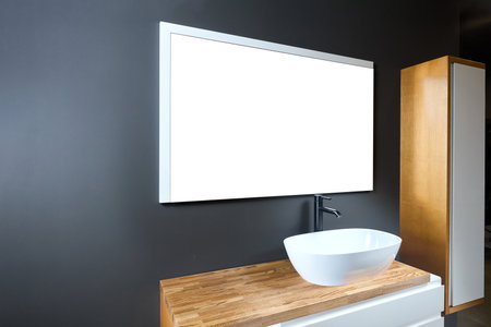 Stand with sink and supplies near dark tiled wall in bathroom with dim lights semi darkness twilight and mirror with frame mockup copyspace Contemporary bathroom detail of rustic loft interior conceptの写真素材
