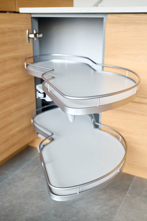 Kitchen access mechanism for Blind Corner Cabinets. Solution for a kitchen corner storage in cupboard. Corner unit with pull out shelves, for cookware.の写真素材
