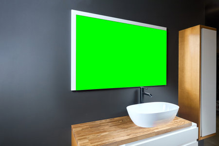 Stand with sink and supplies near dark tiled wall in bathroom with dim lights semi darkness twilight and mirror with frame mockup, copyspace. Contemporary bathroom detail of rustic loft interior concept.の写真素材