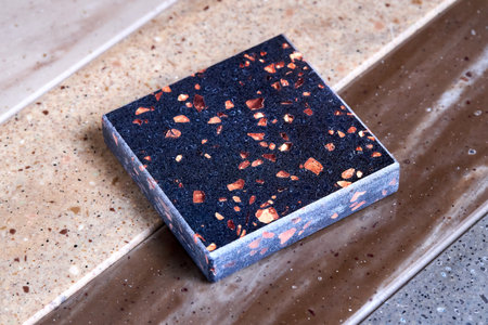Porcelain stoneware artificial stone square samples as kitchen countertop examples of future kitchen fasade exterior. Samples slabs of natural granite marble quartz for stone countertops close up.の写真素材