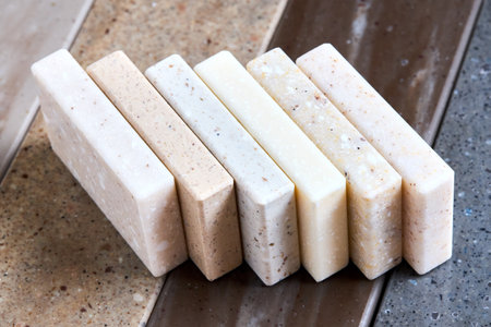 Porcelain stoneware artificial stone square samples as kitchen countertop examples of future kitchen fasade exterior. Samples slabs of natural granite marble quartz for stone countertops close up.の写真素材