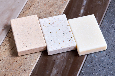 Porcelain stoneware artificial stone square samples as kitchen countertop examples of future kitchen fasade exterior. Samples slabs of natural granite marble quartz for stone countertops close up.の写真素材