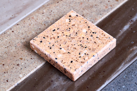 Porcelain stoneware artificial stone square samples as kitchen countertop examples of future kitchen fasade exterior. Samples slabs of natural granite marble quartz for stone countertops close up.の写真素材