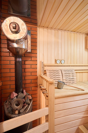 Sauna bathhouse interior with Linden Lining walls and ceiling. African oak bench, lanterns, hygrometer, thermometer for traditional rejuvenation, recovery and restoration, recreation of healthの写真素材