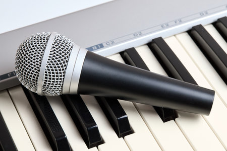 Microphone on midi piano keyboard keys. Recording studio conceptの写真素材