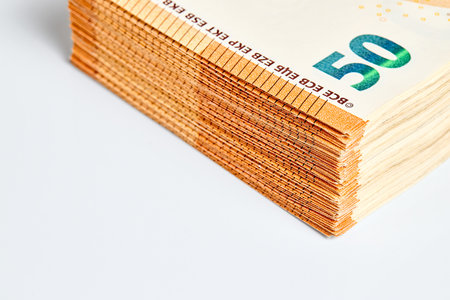 Corner of stack of 50 euro 2017 banknotes over white background close up with copy spaceの写真素材
