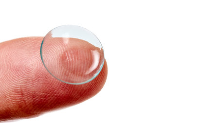 Contact Lens on finger phalanx isolated on white close up shot 16x9 with copy spaceの写真素材