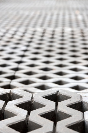 Checkered Concrete Cinder Tiles Of A Garden Sidewalk Lawn In Palette. Turf Grass Block Paving Stones. Grasscrete is eco friendly material for driveways, parking lots or garages instead of concreteの写真素材