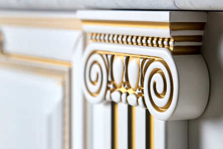 Selective focus fragment of golden and white cabinetry kitchen carved detail. Carved decorative...