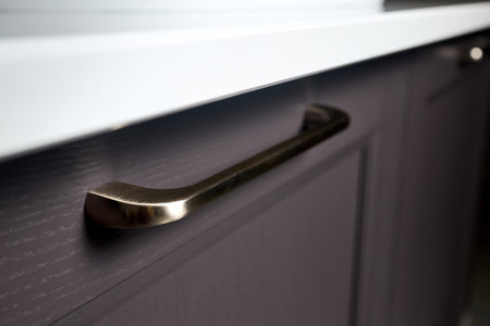 Handle brass classic of cabinet doors, kitchen bathroom cabinet Silk gray solid ash wood painted cupboard cabinet door fitting selective focus close up.の写真素材
