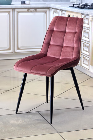 Soft comfortable red modern chair, over out of focus interior kitchen backgroundの写真素材