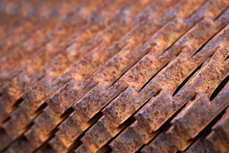 Perforated rusty metal floor sheet stamping plates texture closeup angled view. Metal stamping sheet metal manufacturing lightweight bearing flooring elements structural combine strength functionalityの写真素材