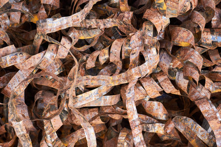 Pile of rusty metal scraps used metal braid of high voltage cable texture. Scrap metal recycling,...