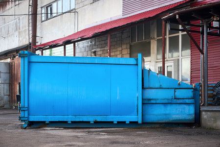Press Container Compactor for Reducing Volume in yard of large hypermarket mall. Press Container Compactor for Reducing Volume of Municipal and Industrial Waste. Waste recycling concept.の写真素材