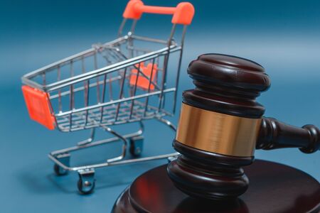 Justice hammer in the foreground, shopping cart in the backgroud.の写真素材