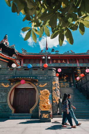 Pedestrians passing by Tua Pek Kong Temple, Bintulu.