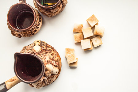 Beautiful ceramic service with small cups next to pieces of sugarの写真素材