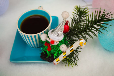 Christmas grandpas toy on a blue saucer with a striped cupの写真素材