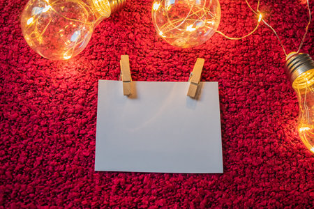 The white card with place for inscription with clothespins next to it is a garland