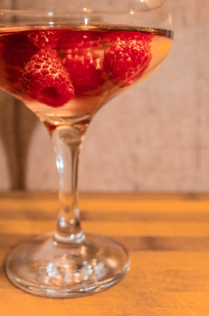 Alcoholic cocktail of rose wine with raspberry berries close-upの写真素材