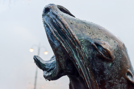 Head of Sea lion is the part of Havis Amanda statue in Helsinki. There is visible street lights in background and its looks like Sea lion trying to catch itの写真素材