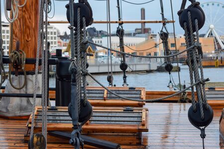 Old ship deck view from the side in the cloudy and rainy day. In the background visible city of Helsinki in Finlandの写真素材