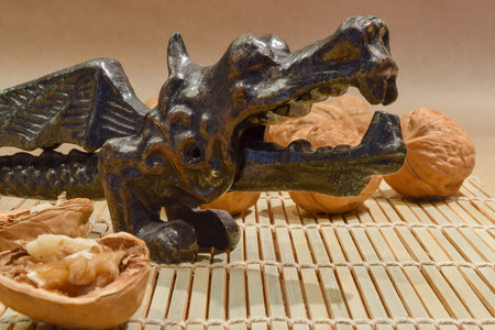 Very old dragon shape nutcracker with the walnut in jawsの写真素材