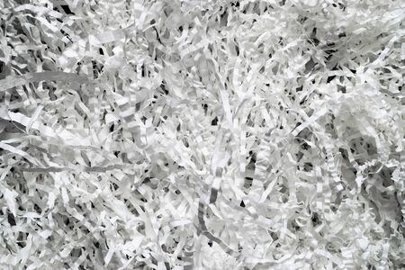 Shredded white curly paper strips background on black backgroundの写真素材