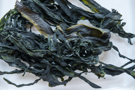 Dry bunch of seaweed in white background surface close up viewの写真素材
