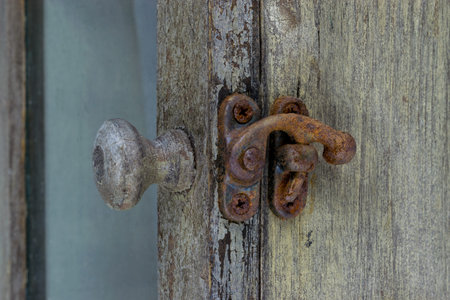 Very old shelf with rusty lock and handle. Little bit visible remains of green paint and varnish