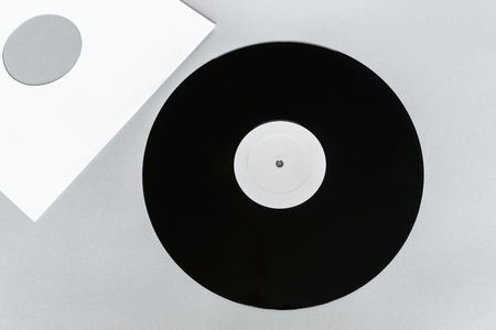 Vinyl LP on gray background surface with copy free space and white envelope near itの写真素材