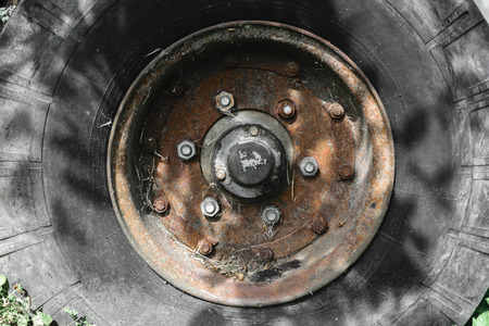 Background surface of old and dirty tire with rusty discの写真素材