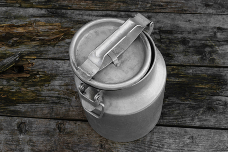 Drying Washed Metal Milk Canisters, Churns in the Countryside on the wet wooden backgroundの写真素材