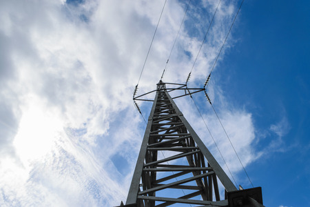 Metal electricity pole in blue sky with white clouds backgroundの写真素材