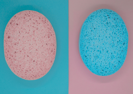 Pink sponge on blue background and blue sponge on pink background surfaceの写真素材