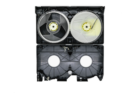 Background surface of inside open video home system tape reels and plastic tray isolated on white backgroundの写真素材