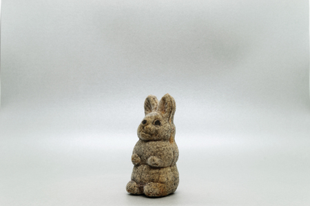 Very old bunny soft toy on grey background surface with copy spaceの写真素材