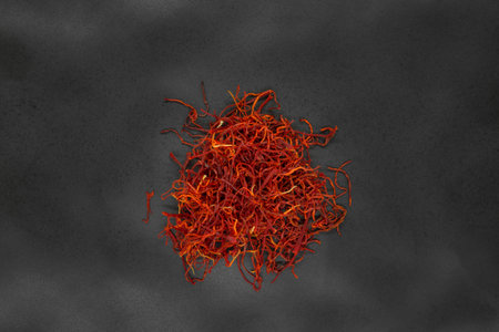 Bunch of red and dry Saffron spices on black background