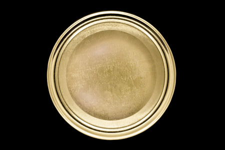 Round, scratched and golden jar lid isolated on black backgroundの写真素材