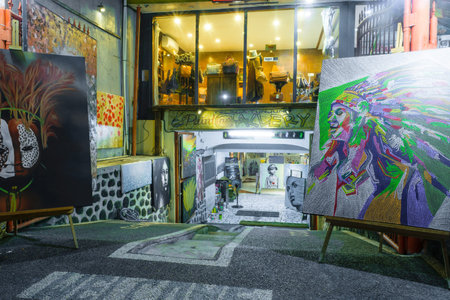 Bali, Indonesia 12 OCT 2018. Nightlife street in Bali and painting shop in basementのeditorial素材