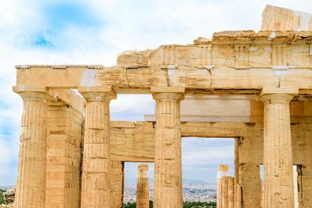 Mountains and Athens cityscape view between pillars of propylaea monumental gateways to Acropolis in...