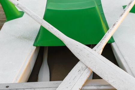 Background of green and white water paddle boat and paddles on sea sand at the beachの写真素材